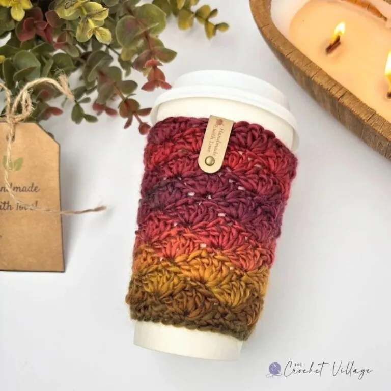 Autumn crochet cup cozy in rust, orange, and brown shell stitch worsted-weight yarn