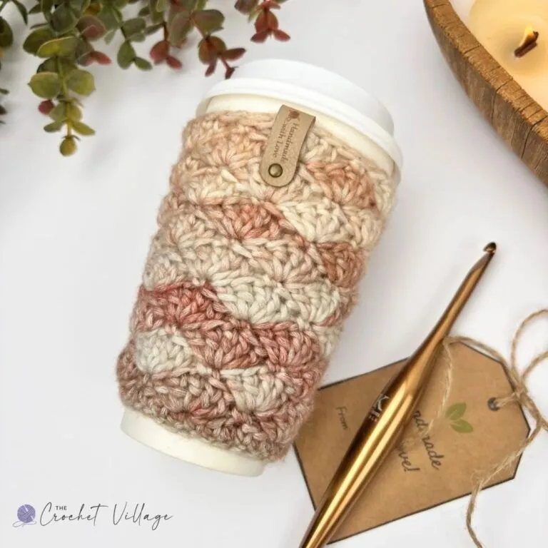 Neutral cream and beige crochet cup cozy worked in shell stitch with a handmade gift tag