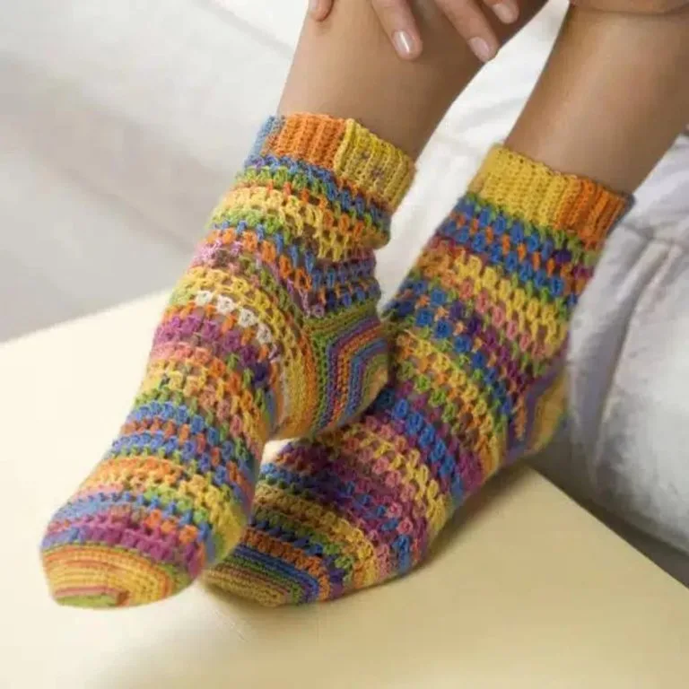 Feet in colorful handmade crochet socks, adding a cozy and vibrant touch.