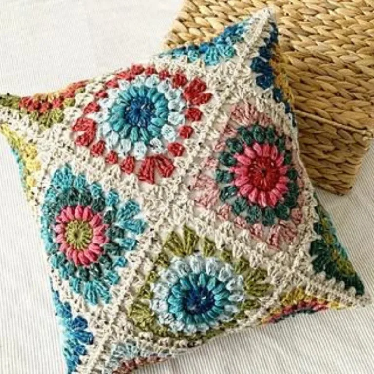 A stunning crochet granny square pillow, making a great housewarming gift idea with its colorful, handmade charm.