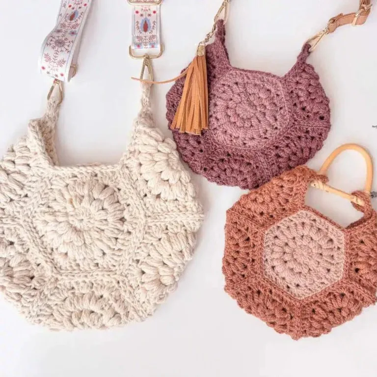 Three hexagon crochet purses in three different sizes, showcasing a stylish and versatile design.