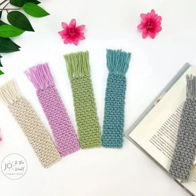 Five crochet bookmarks displayed with an open book