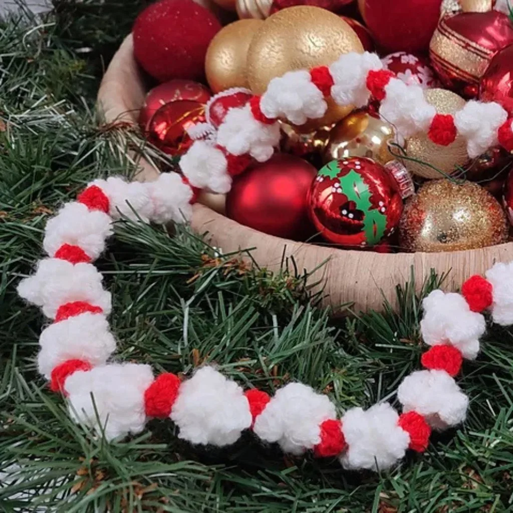 A basket filled with Christmas glass baubles and a crochet garland.