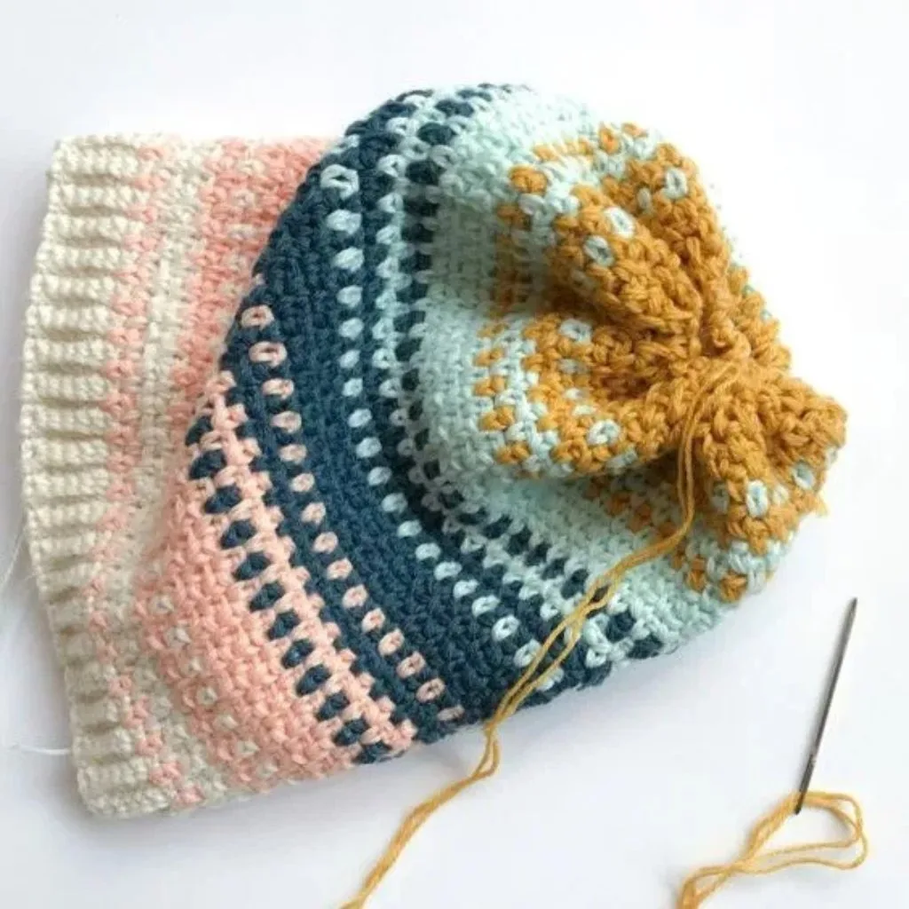 A stripped crochet scarf with fringe.