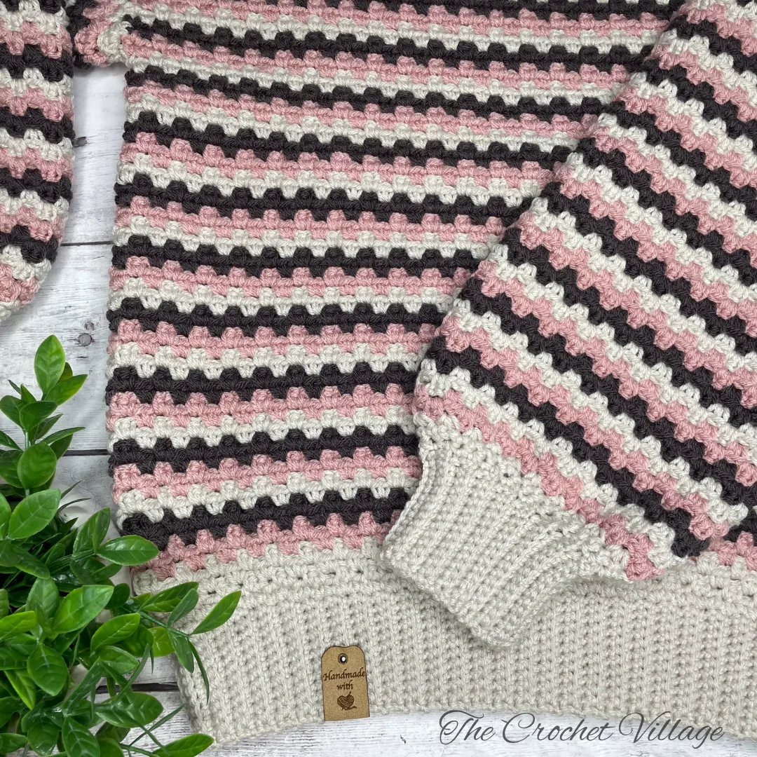 Close-up of ribbed cuffs and hem on oversized Arcadia crochet sweater for women