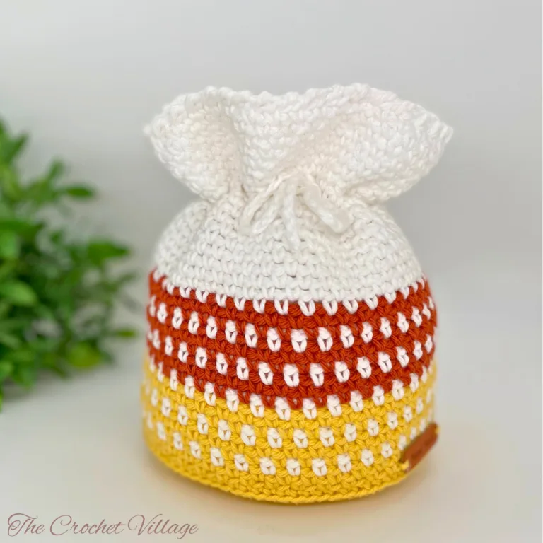 Crochet candy corn-inspired drawstring bag for Halloween treats and fall decor