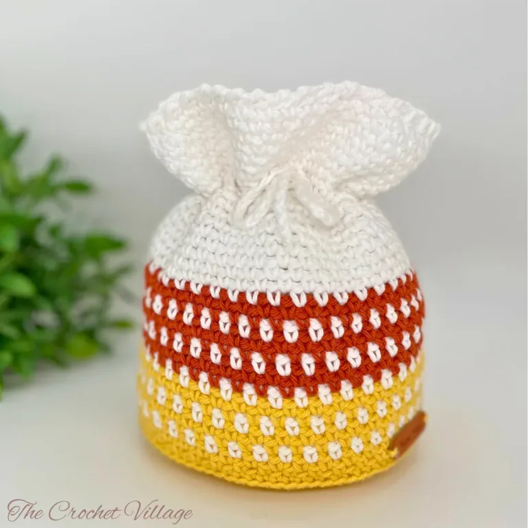 Crochet candy corn-inspired drawstring bag for Halloween treats and fall decor