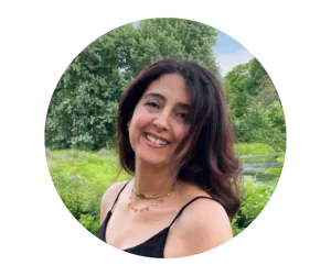 A picture of a women outdoors smiling.