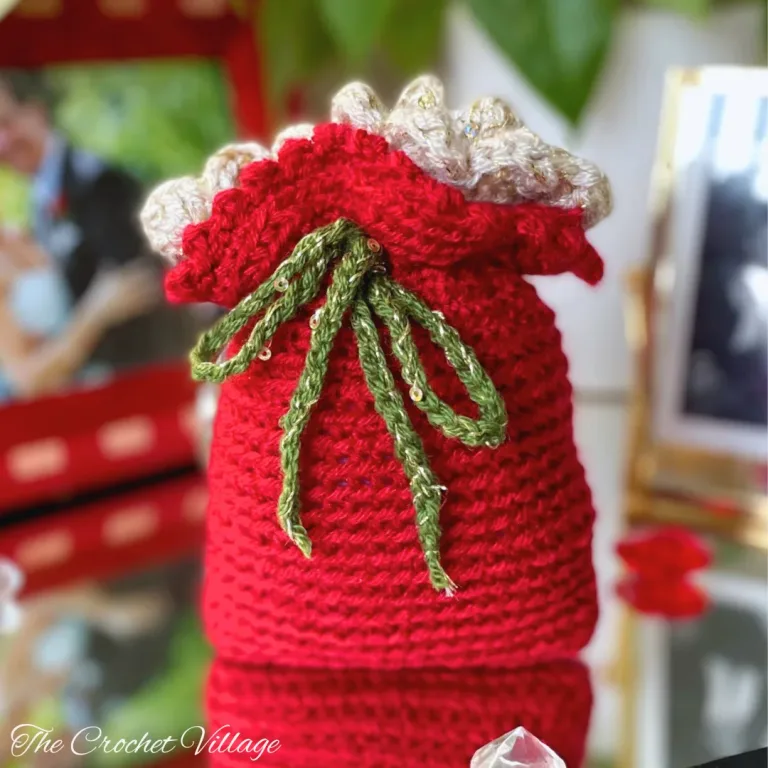 Handmade crochet drawstring pouch using the Noel Gift Bag free crochet pattern – perfect for Christmas gifts, party favors, or small treats