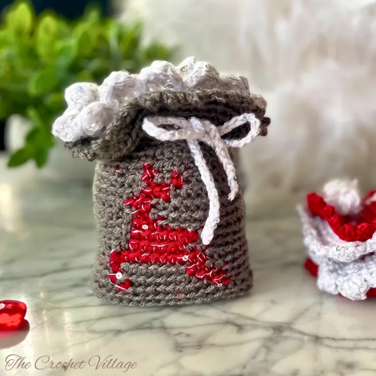 Crochet Reindeer gift bag featuring a drawstring and scalloped edging.