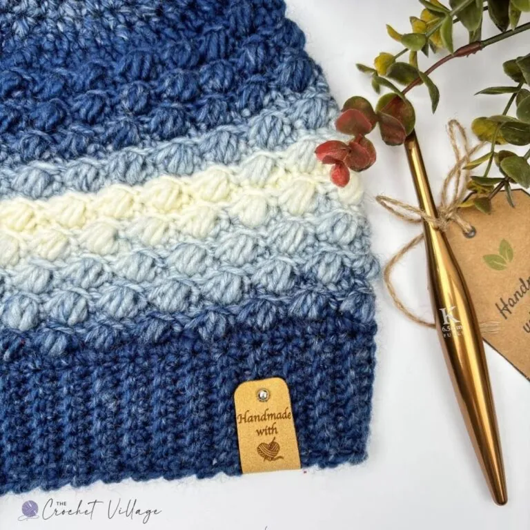 lose-up of a crochet hat featuring a gorgeous textured stitch and a soft, comfy ribbed brim – part of a free textured crochet hat pattern for women.