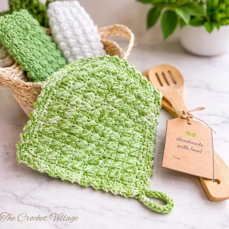 Handmade crochet potholder and basket of hot pads on a kitchen counter – free crochet pattern