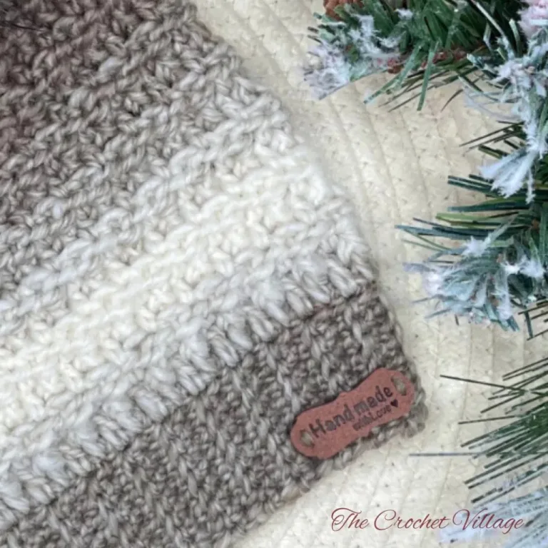 Close-up of a crochet hat ribbing with a leather tag, showcasing the detailed texture and neat stitches