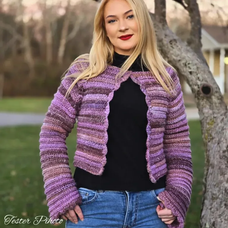 A young woman wearing a beautiful, simple cropped crochet cardigan, showcasing a stylish and effortless look.