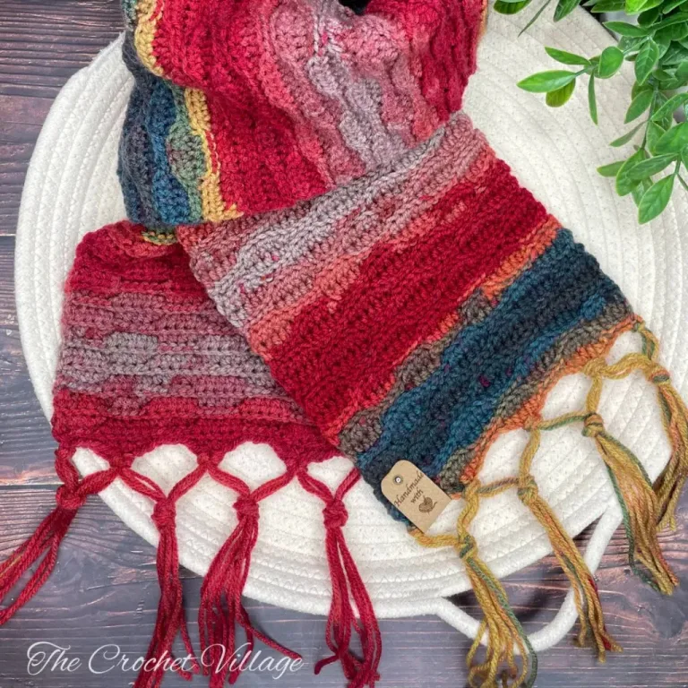 A colorful crochet scarf with a fringe.
