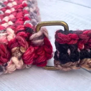Two crochet pieces attached with a metal rectangl