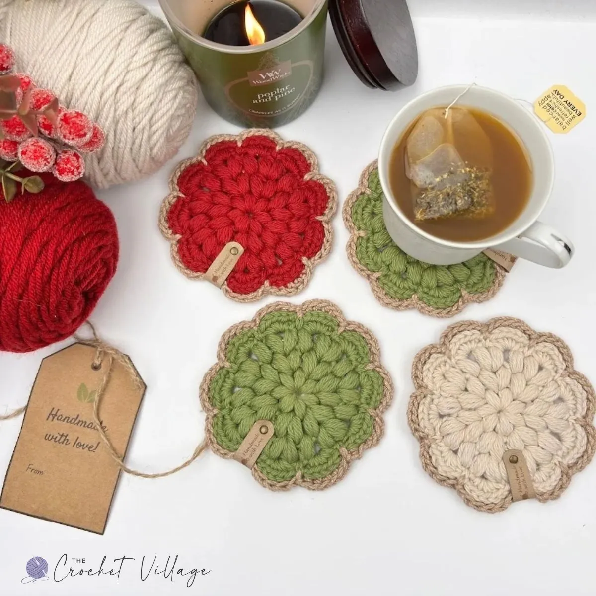 Set of firm crochet Noel coasters in red, cream, and green, showcasing textured puff stitches and handmade tags