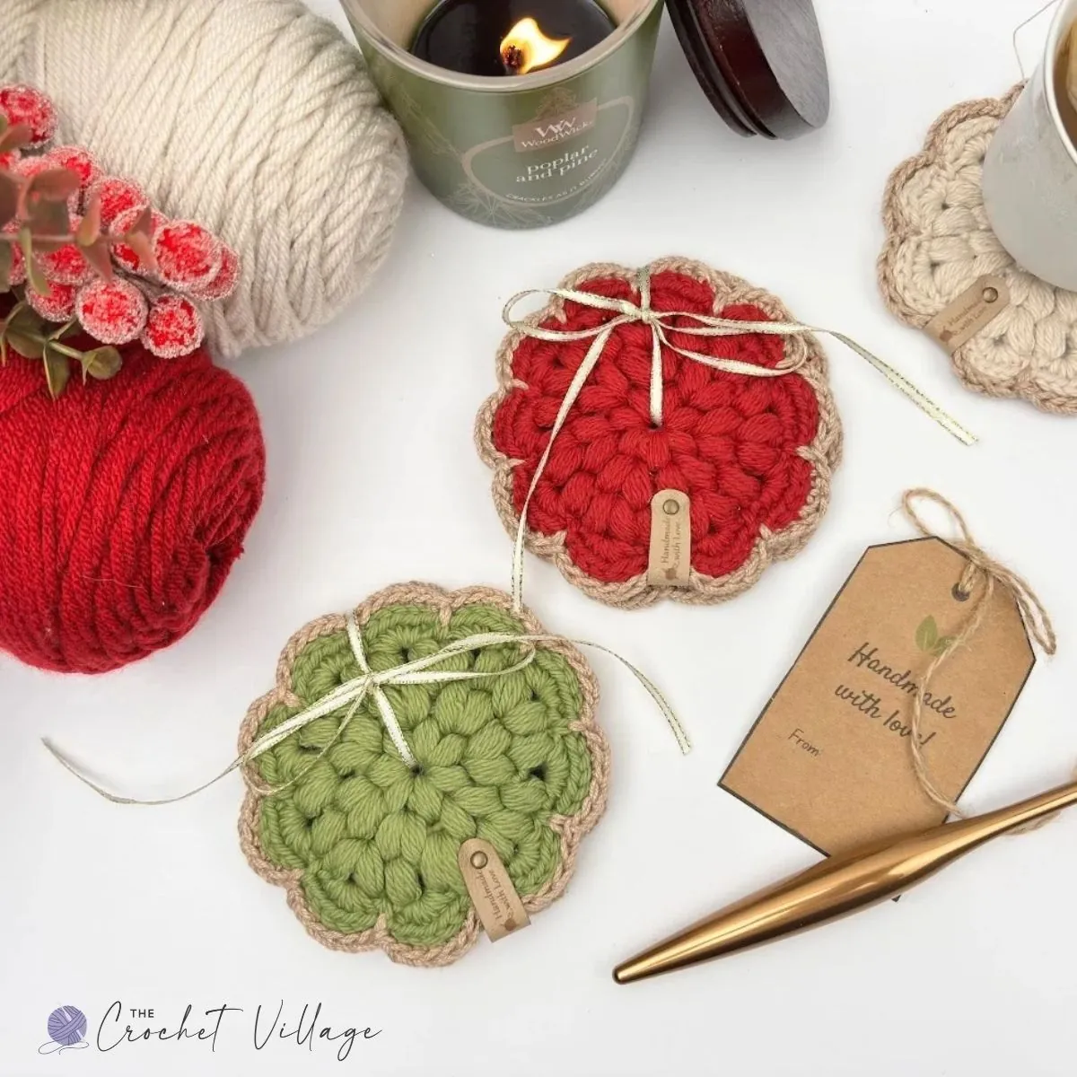Close-up of red crochet Noel coaster featuring puff stitch and contrasting golden edging, surrounded by yarn