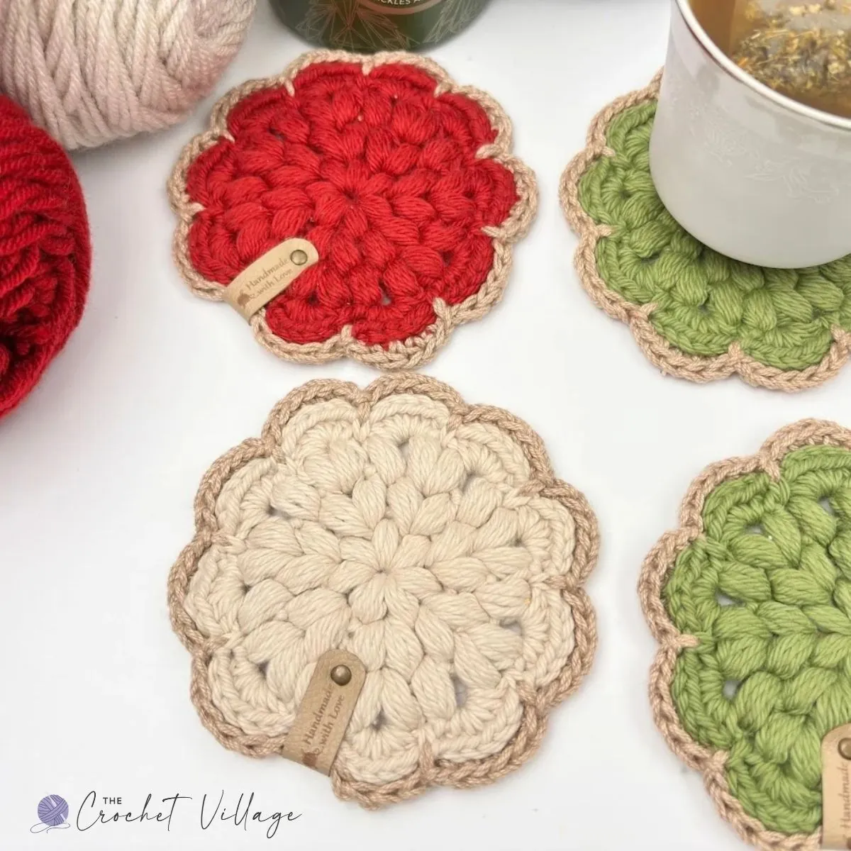 Colorful Noel crochet coasters in red, cream, and green with puff stitch texture and a scalloped border