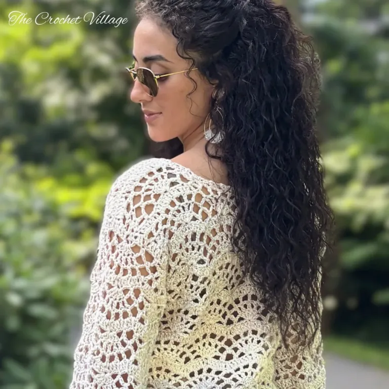 Lightweight crochet Charlotte sweater pattern modeled on woman, lacy summer top