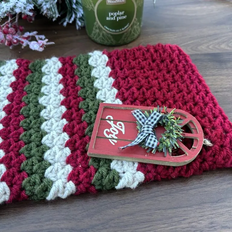 Close-up of classic crochet stocking showing detailed one-row repeat textured stitch on wooden background