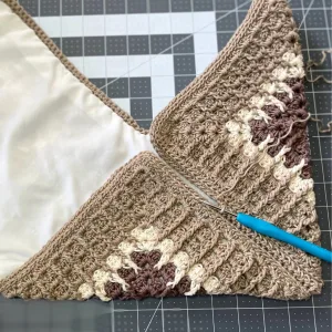 An image demonstrating how to attach a lined crochet granny square to each other to form the bag.