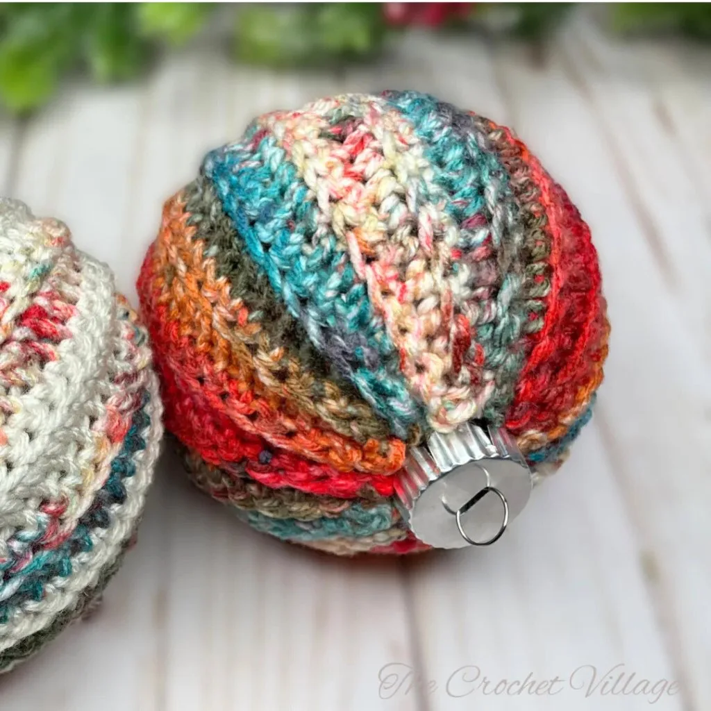 A colorful vintage style crochet Christmas bauble cover made with the Jolly ornament free crochet pattern.