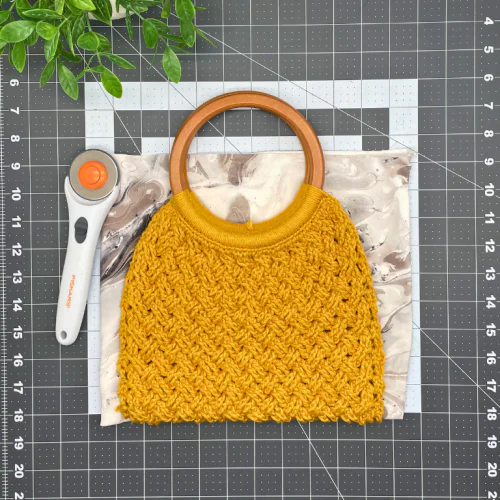 Cutting fabric for lining a crochet bag, showing the easy step-by-step lining process for the Naomi crochet handbag pattern