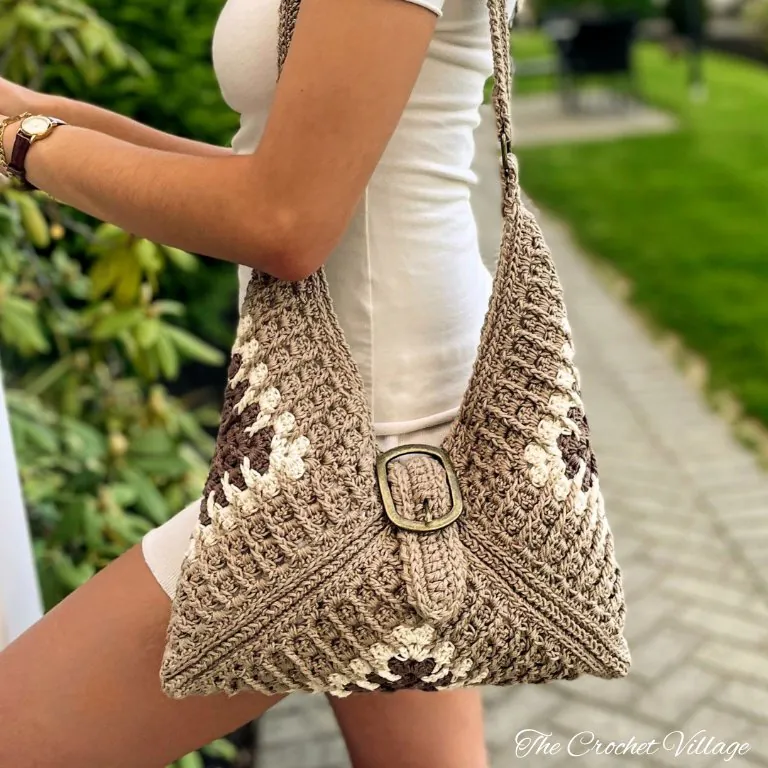 Woman wearing Vicki granny square crochet shoulder bag in multicolor with handles over shoulder