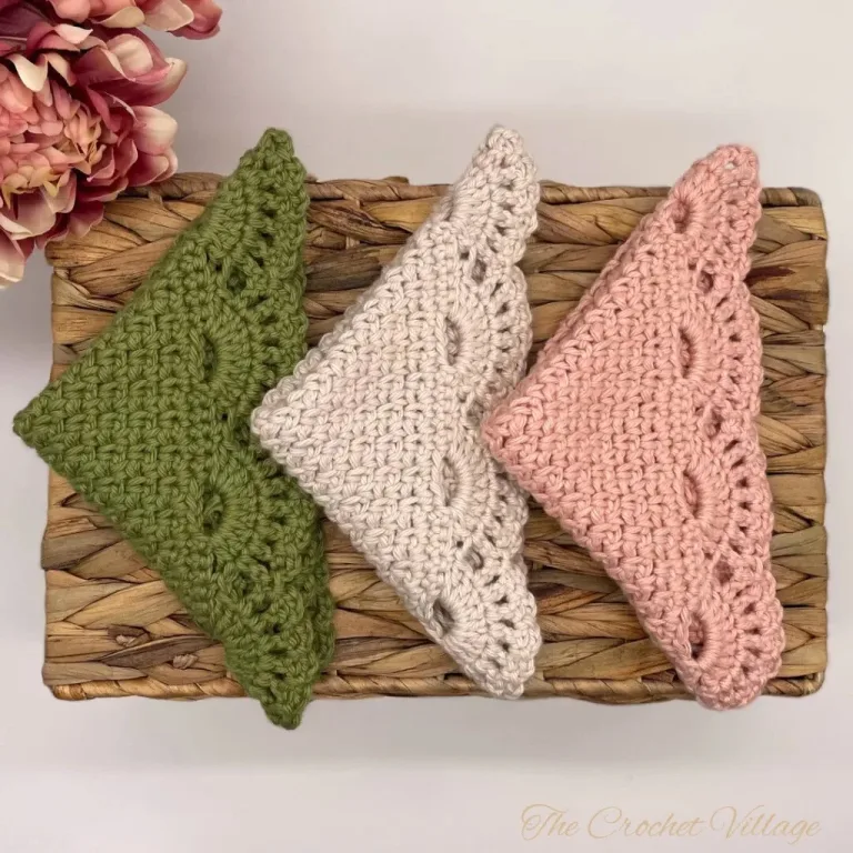 A set of three washcloths with a beautiful lacy border, neatly displayed with floral decor.