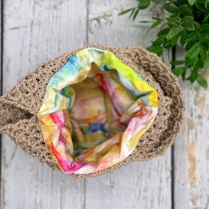 A close-up view of the neatly sewn fabric lining inside a crochet Japanese knot bag.