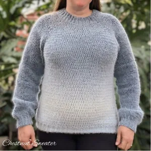 A plus-size woman wearing a simple long sleeve crochet pullover that fits her beautifully.