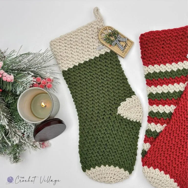 Solid green crochet Christmas stocking with cream cuff, heel and toe, beside a red and green striped version