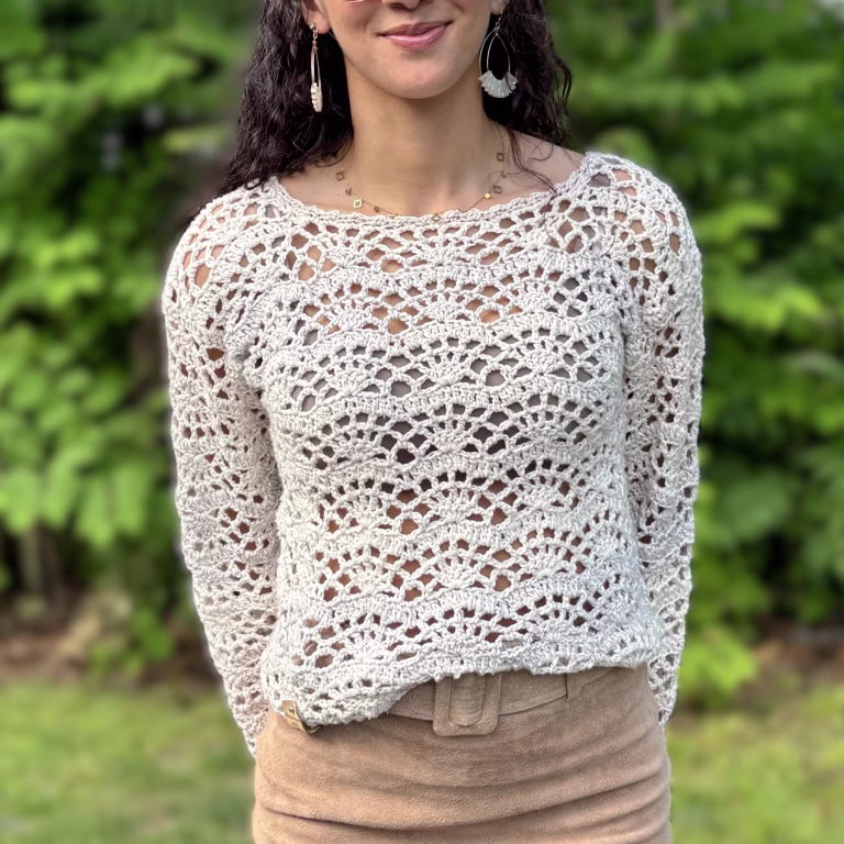 Girl modeling cream colored lightweight crochet Charlotte lacy sweater, front view