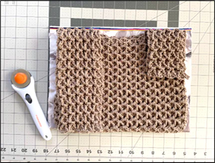 Free crochet Japanese knot bag tutorial showing how to sew and secure the lining inside the bag for a polished finish.