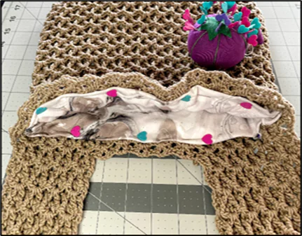 Free crochet Japanese knot bag tutorial showing how to prepare and insert the fabric lining into the bag.