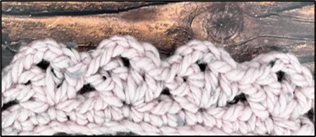 Close-up of crochet Japanese knot bag stitch pattern in progress showing textured one-row repeat stitch tutorial