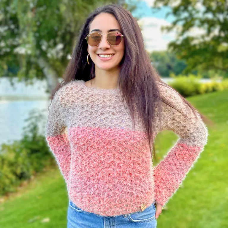 A young woman wearing a fluffy crochet sweater