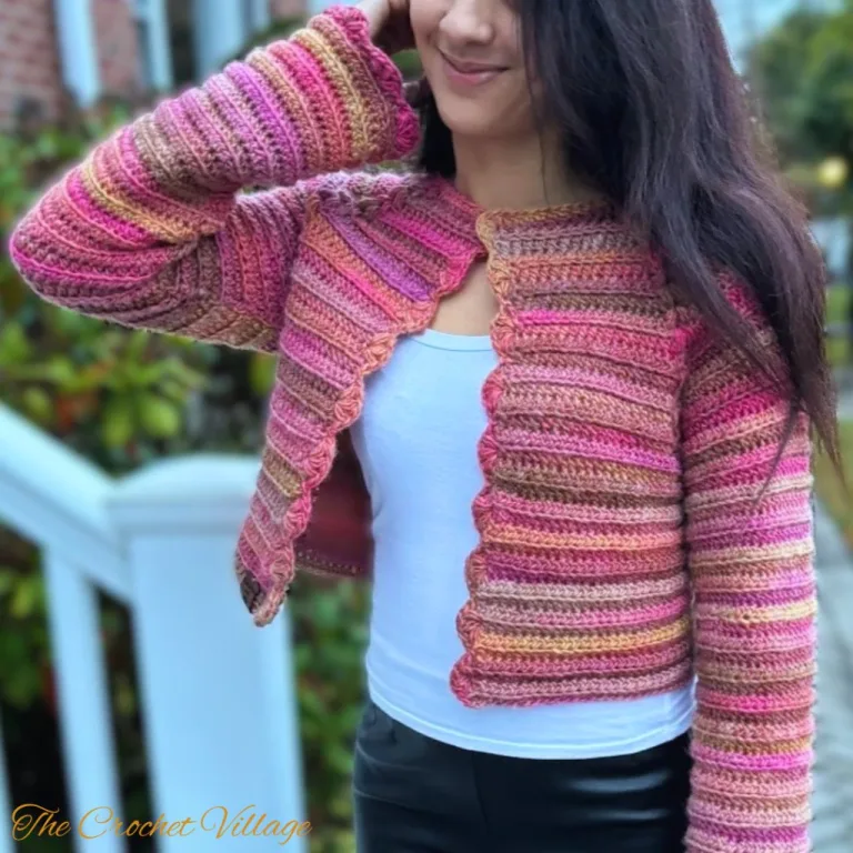 A girl wearing a colorful light weight cropped cardigan made with Lexington cardigan free crochet pattern