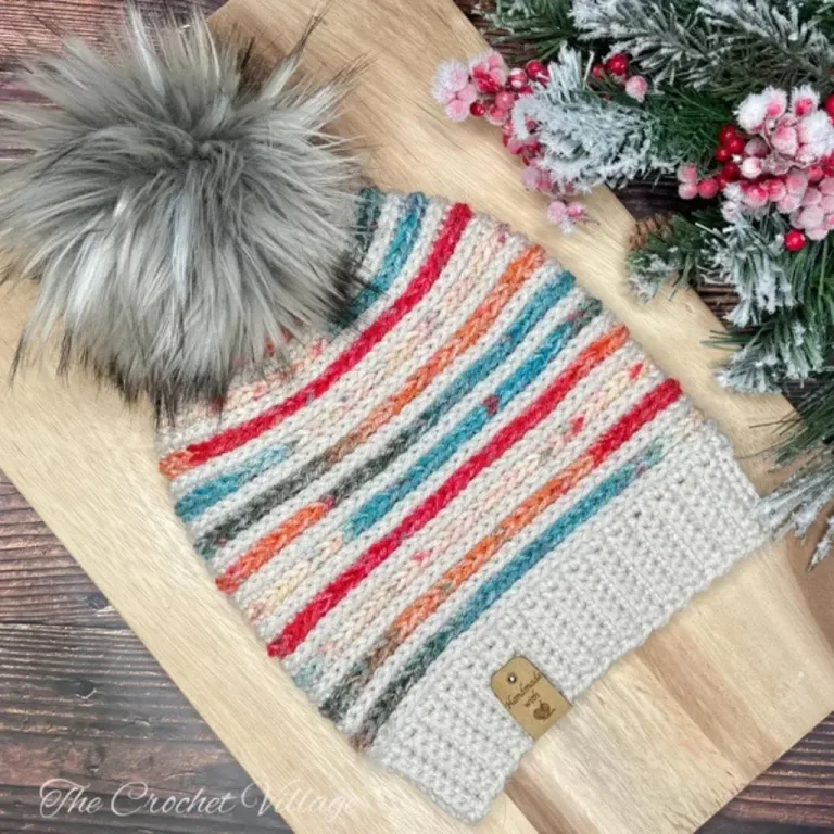 Colorful crochet hat with a large pom pom made with the Symphony hat crochet Pattern.