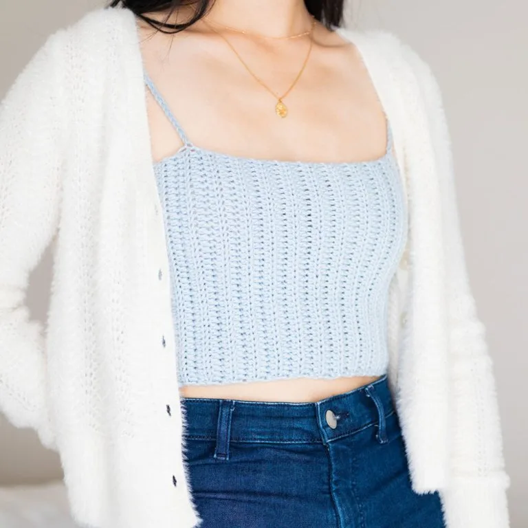 A lady wearing a simple, delicate crochet crop top, showcasing its lightweight and elegant design.