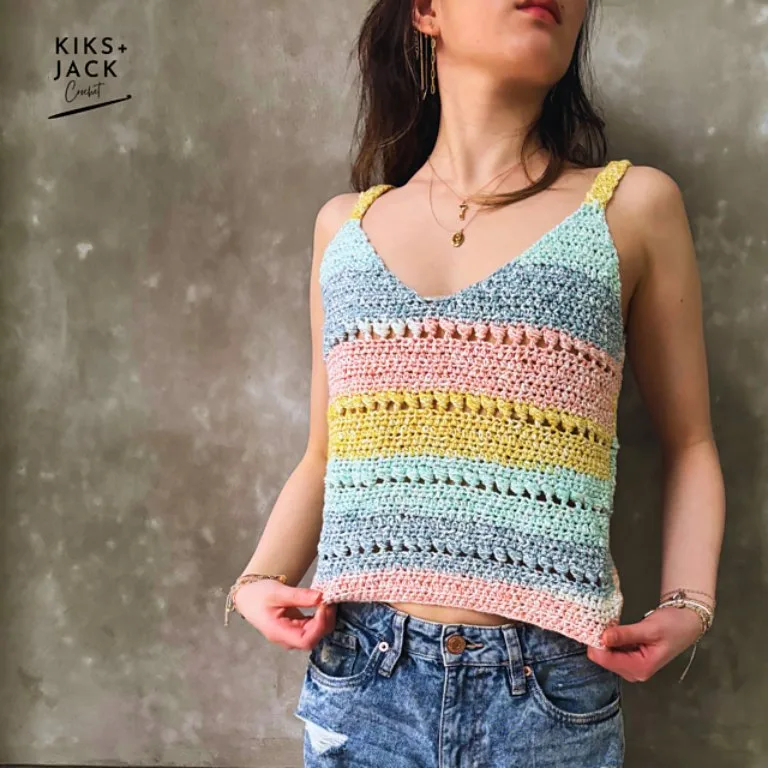 A woman wearing a colorful relaxed crochet tank top.