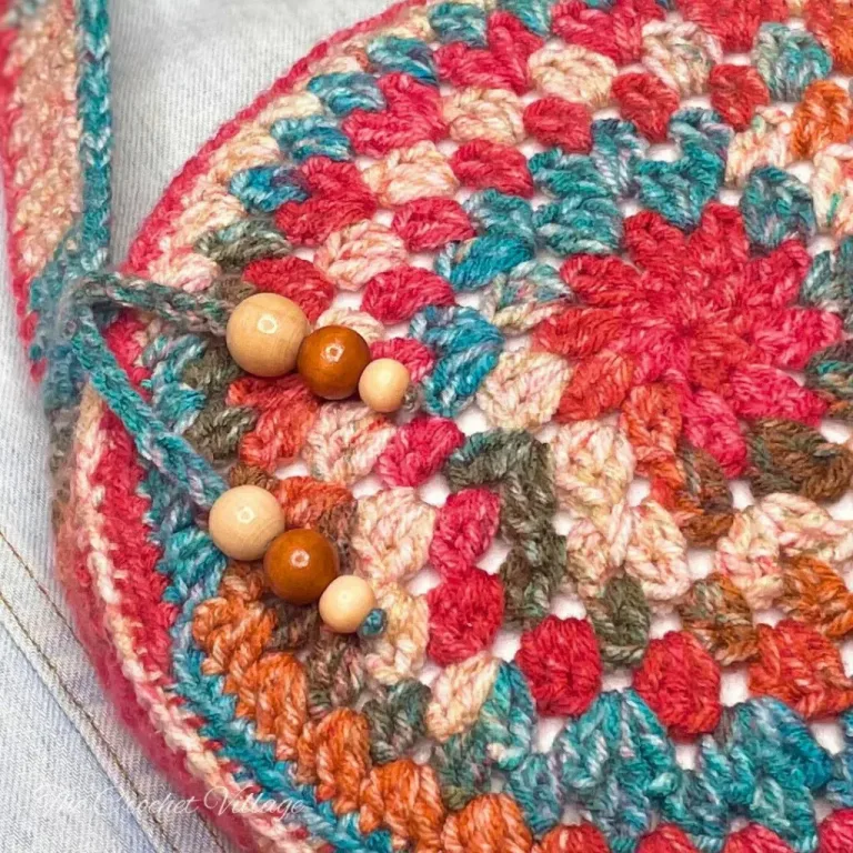 A close-up of a crochet round piece in vibrant boho colors, showcasing intricate stitches and texture.