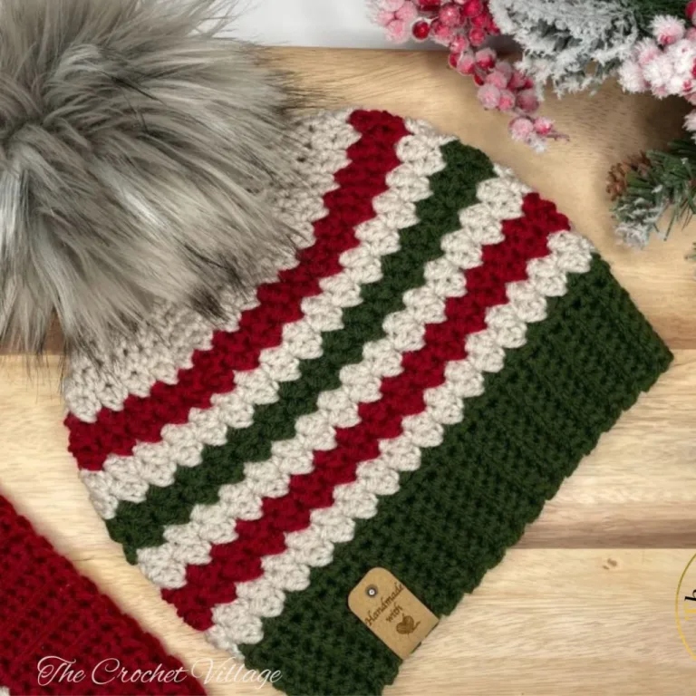 Crochet Hat in Christmas color on a wooden surface with a christmas decor