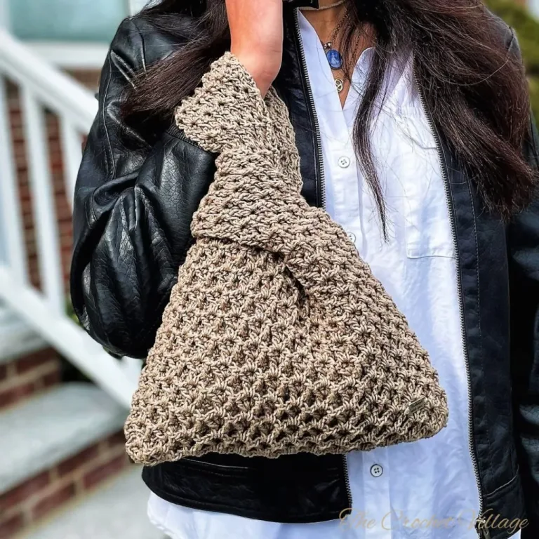 A girl talking on the phone while holding a handmade crochet Japanese knot bag.