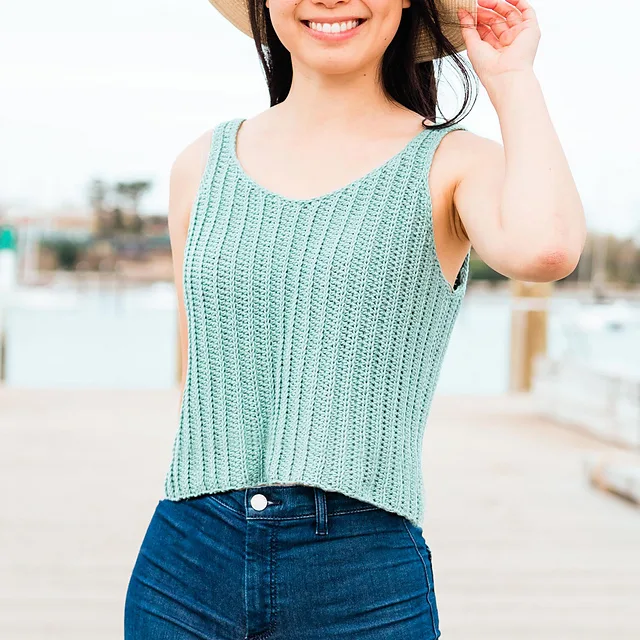 A young lady wearing a lightweight crochet tank top, enjoying the sunshine.