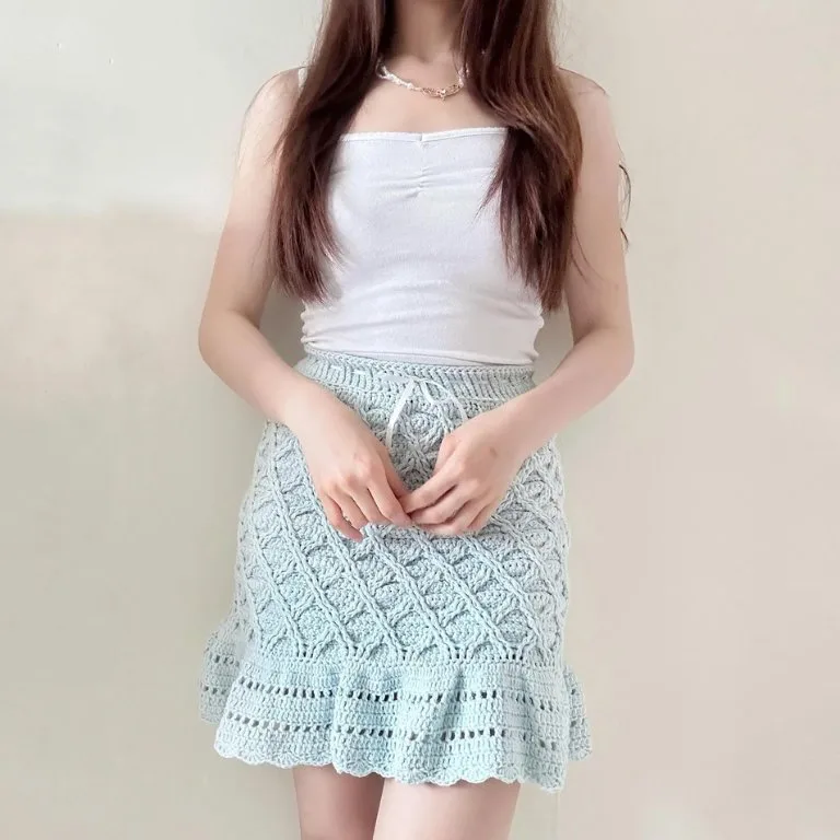 A person wearing a lightweight, fun, and simple crochet skirt with cute stitch details, perfect for a casual and stylish look