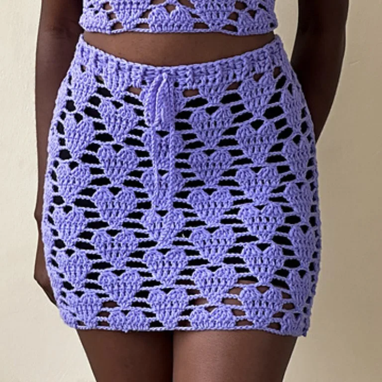 A woman wearing a Crochet Hearts Skirt, a romantic and lacy design perfect for special occasions.