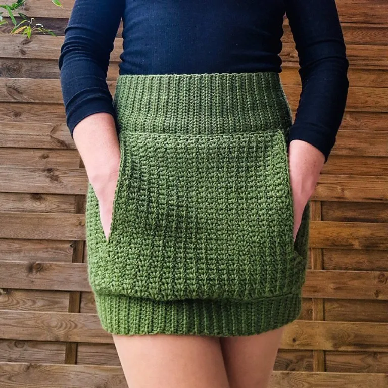 A person wearing a cute crochet mini skirt with pockets