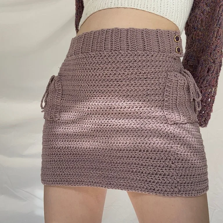 A person wearing a modern cargo-inspired crochet skirt with fun pockets on the sides.